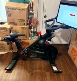 Peloton Exercise exercise stationary bike little use includes touch screen screen can be tilted vertically shoes headphones and weight set
