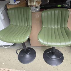 Two green swivel high chairs