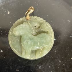 Carved Green Jade Carved Horse Pendant with a Gold Bail . 1.25” D