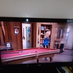 42 inch sanyo flat screen TV with papers and remote
