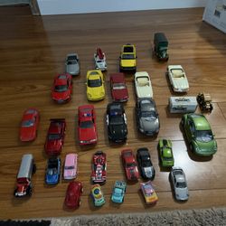 Assorted toy cars in various colors and models. 15 cars with open doors like new and 13 mini cars 