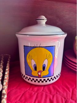 vintage 1993 Warner Bros. Looney Tunes Tweety Bird ceramic cookie jar.The canister is approximately 9 inches tall and features a white checkered desig