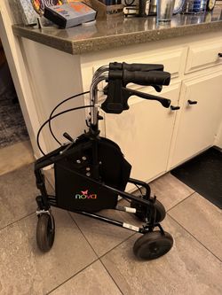 Space saving walker with basket and tray table
