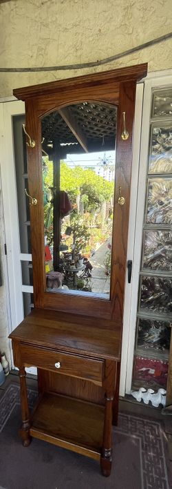 Vintage oak hall tree mirror, brass hooks, and a lower storage drawer