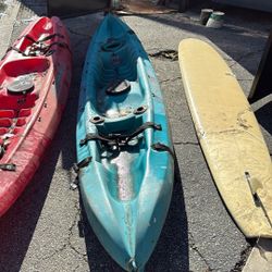 Surfboard And 2 Kayaks