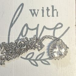 elegant silver necklace features a stunning crystal pendant,