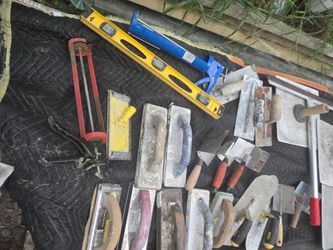 Collection of masonry tools including trowels and levels.$180 Located MountDora Fl 32757