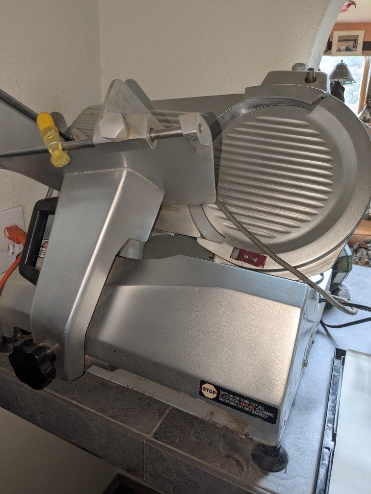 Univex Model 7512 food slicer. It is a medium-duty, manual gravity 12" Blade
