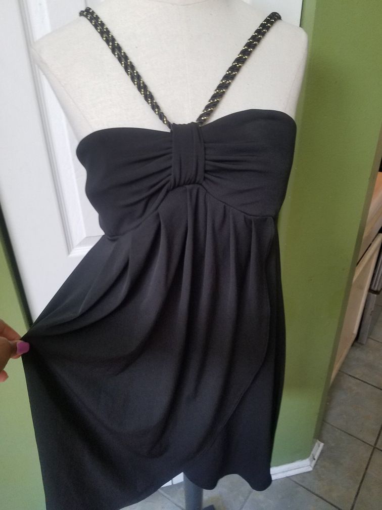 Sexy black dress with black and gold straps.