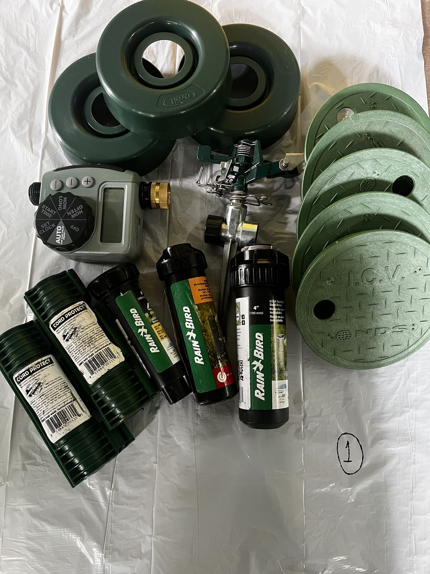 3 sprinkles, 2 cord protect, 1 hose faucet timer, 5 round valve box cover (7in) , 1 sprinkler base and 3 sprinkler guard donut.