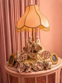 vintage Italian Capodimonte table lamp featuring a detailed porcelain stagecoach /cherubs