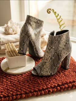 Peep toe snakeskin booties