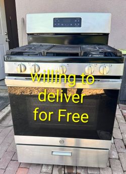 Clean GE stainless steel gas stove available. Features 5 burners plus a center griddle area