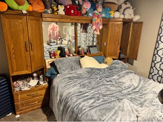 Large Queen sized bed with mirror and cabinets