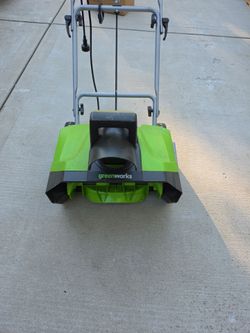 Greenworks, a hundred and twenty volt, thirteen amp snow thrower