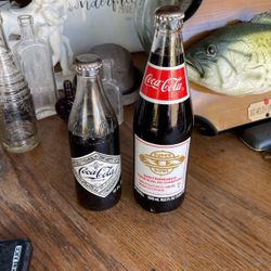 Call Coca-Cola bottles still full soda best offer.