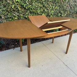 Mid Century Modern Teak Oval Butterfly Leaf Dining Table.