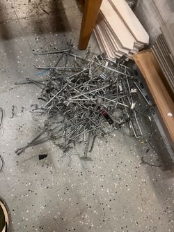 Large Lot of Metal Pegboard Hooks/        This is a pile of assorted metal retail display hooks used for pegboards, slatwalls, or gridwall systems.