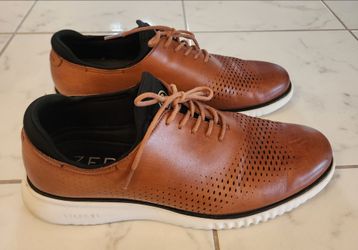 Cole Haan Men's 2.Zerogrand Laser Wingtip Oxford shoes, likely in the British Tan color with a white sole.