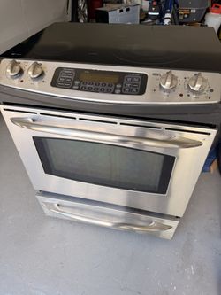 Stainless steel GE glass top convection range and over-the-range microwave set.