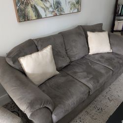 Light Brown Couch With Two Throw Pillows 
