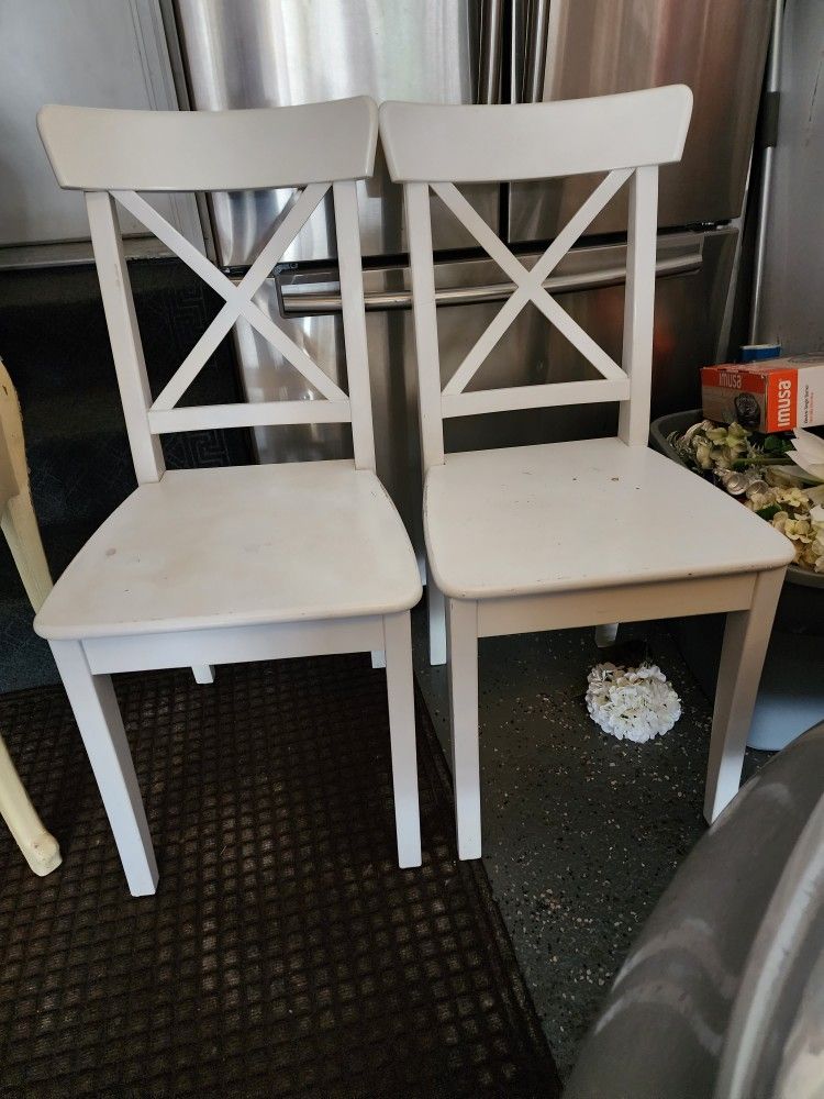 Two wood white chairs