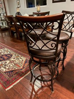 Three matching swivel bar stools