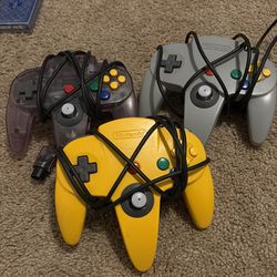 Three original Nintendo 64 controllers