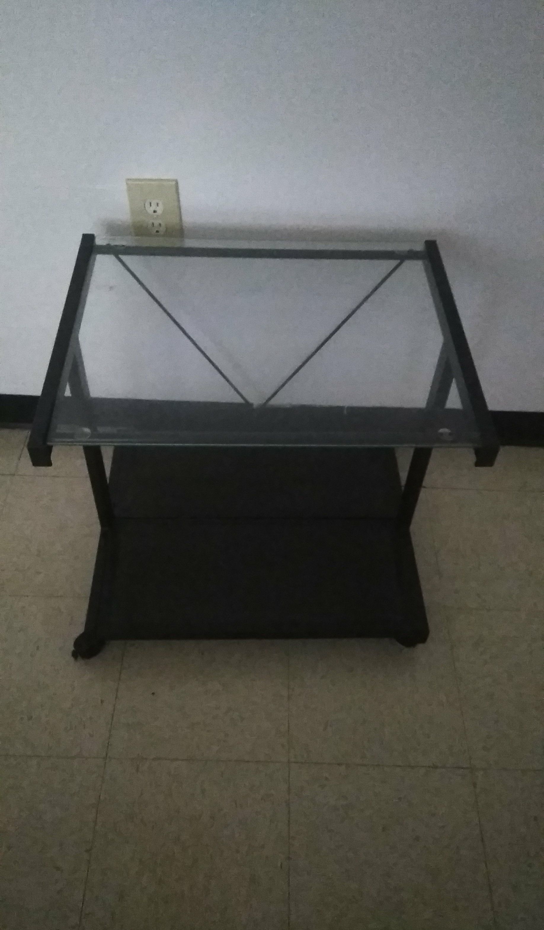 Tv stand on wheels with glass top asking $10. Avon Park pick up only