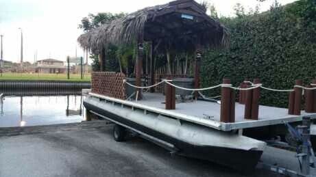 Tiki pontoon boat with trailer.