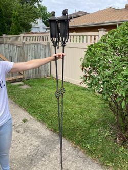 Two nice metal tiki torches
