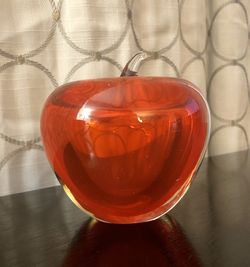 Paperweight collectibles of a glass, red Apple.