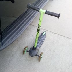 Lil scooter with green led lights on 3 wheels
