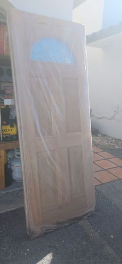 This is a 30" × 80" unfinished, half-lite (fan-lite) exterior door slab crafted from Caoba wood.Caoba wood is the Spanish term for genuine mahogany, a