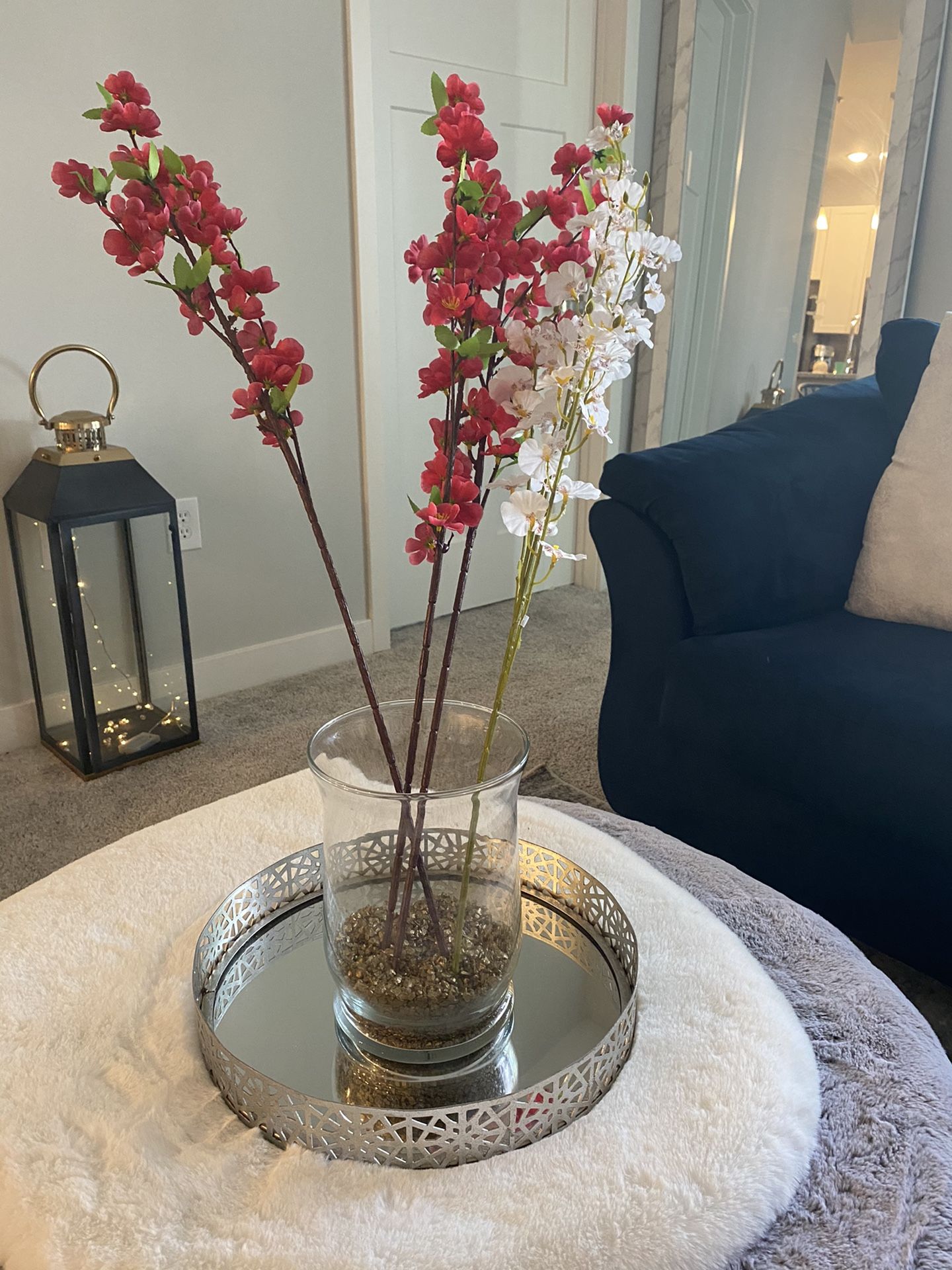 Decorative vase, flowers, and mirrored tray