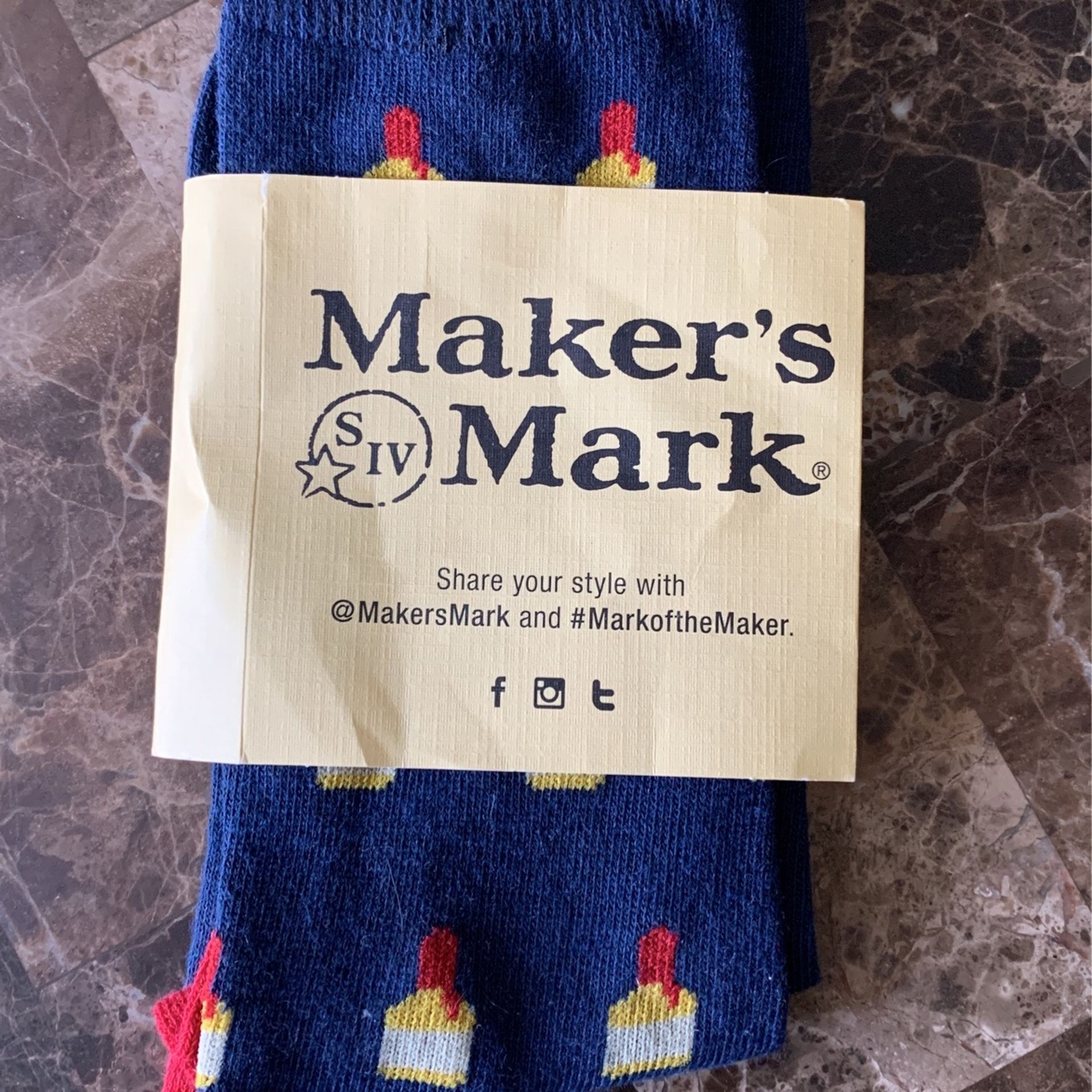 Socks! With cute little makers Mark whiskey bottles all over them navy blue red with a hint of yellow and gray