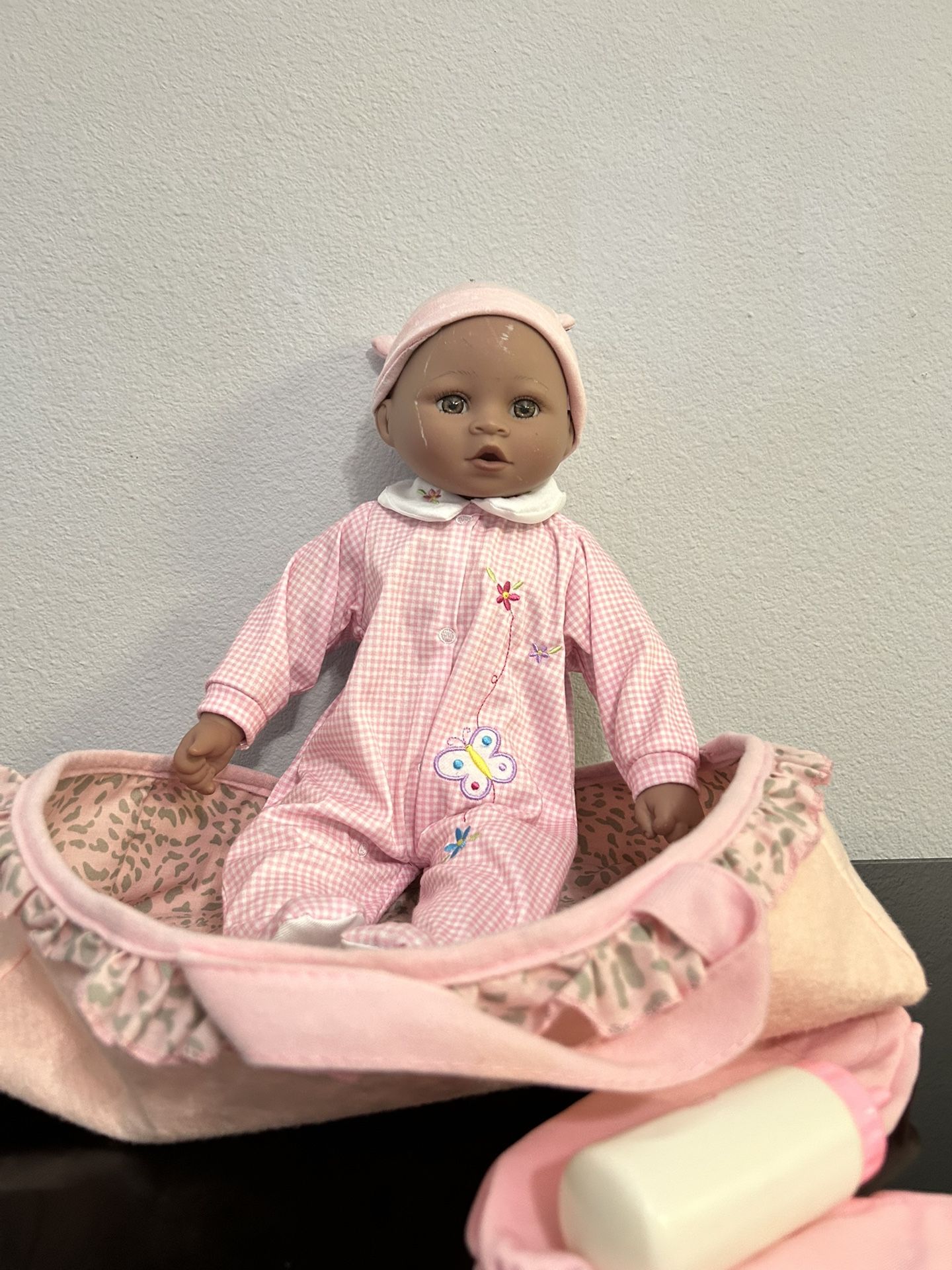 Girl Baby Doll in a pink carrier