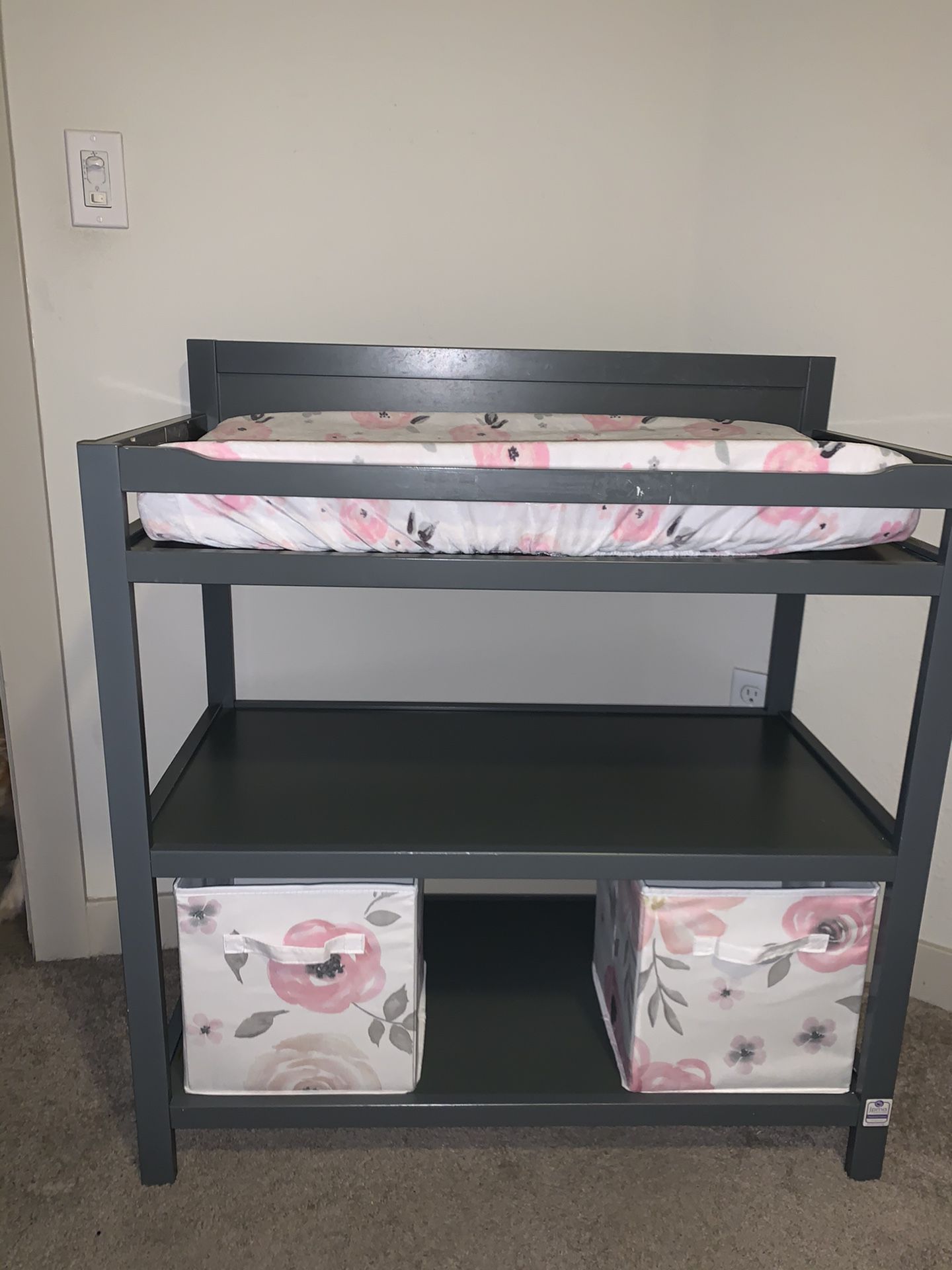 Grey changing table with floral bins