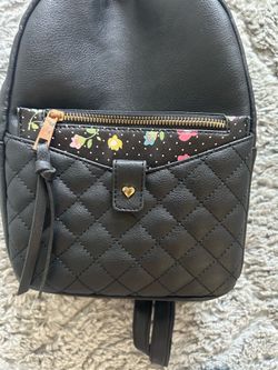 Black quilted backpack with floral wallet