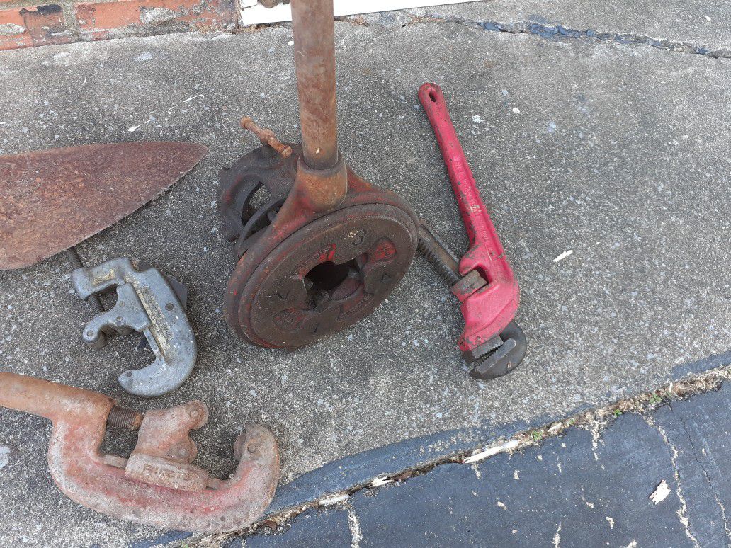 Old pipe threader, pipe cutters and masonry trials
