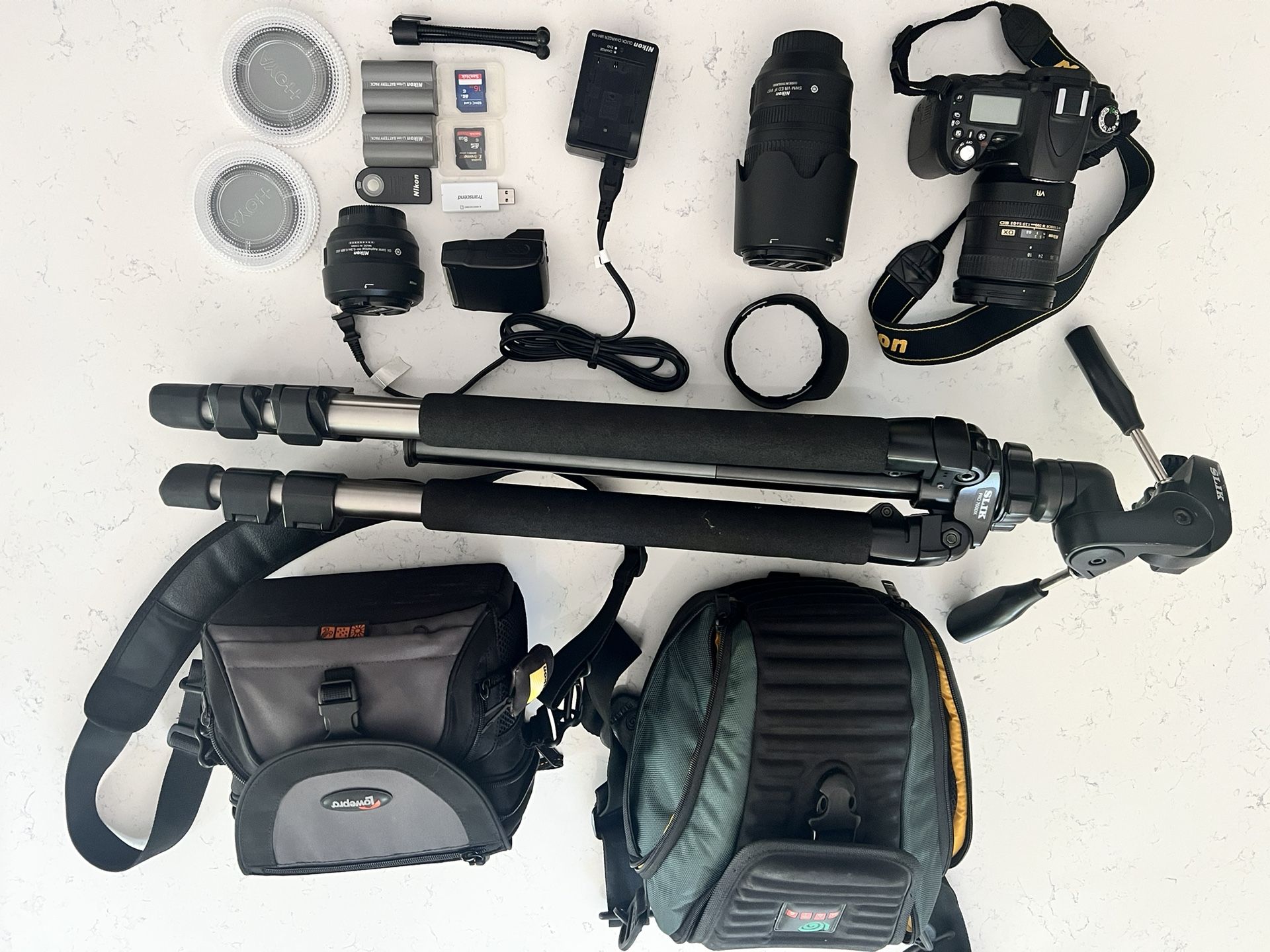 Nikon D90 DSLR Camera with three lenses, bags, tripod, filters, flash