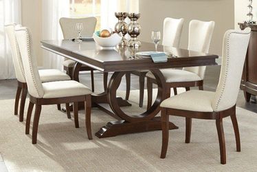 Traditional styling dining set features cherry finish & unique styling base