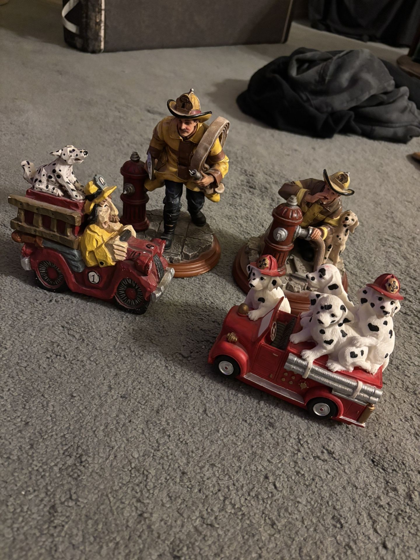 Vintage firefighter and Dalmatian figurines and collectible statues