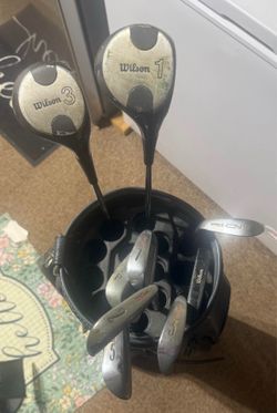 Golf clubs and bag and balls