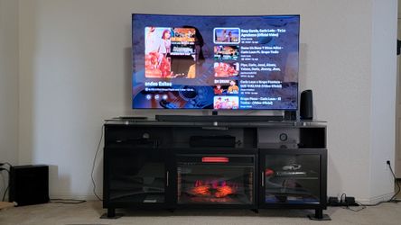 65 inSamsung  curved smart TV with Samsung curved sound bar and sub plus TV stand with fireplace
