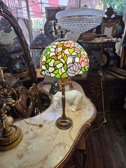 Tiffany-style table lamp with a stained-glass shade featuring pink and green roses