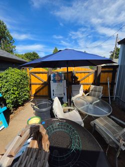 Heavy duty umbrella holder with a blue tilt umbrella