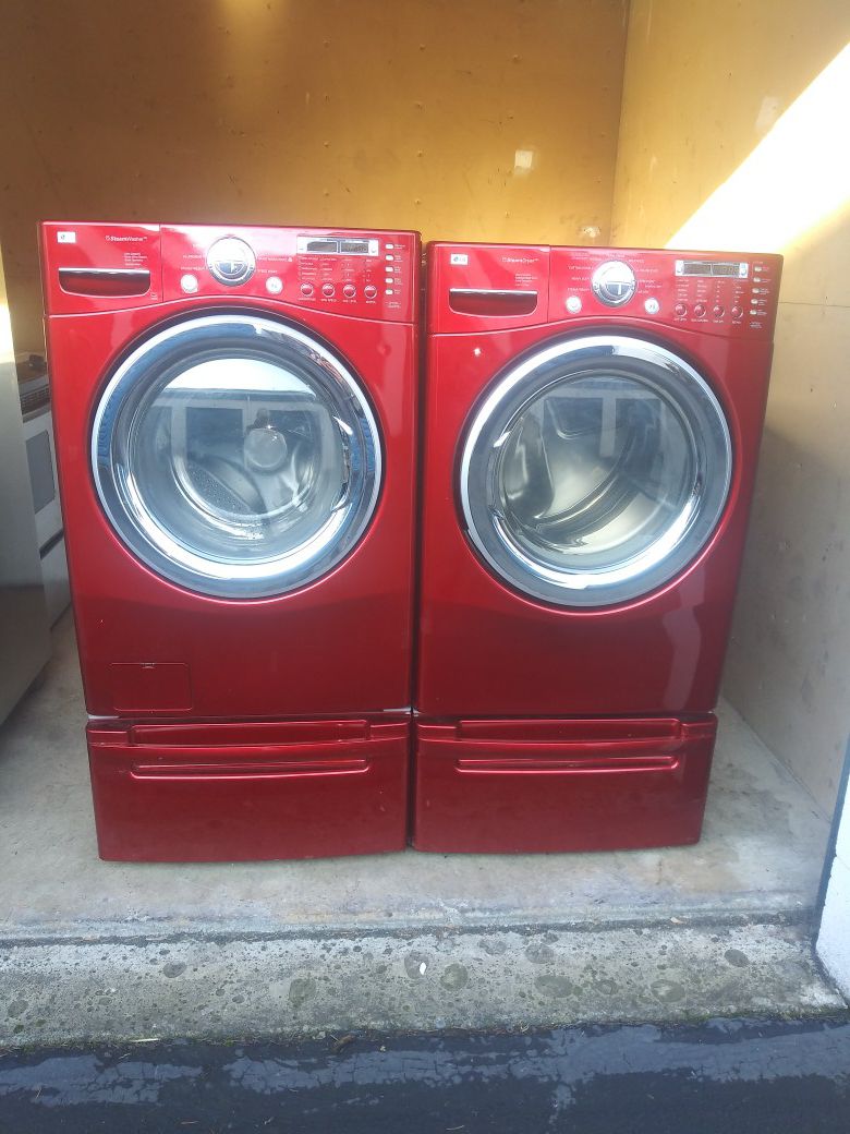LG RED FRONT LOAD WASHER AND DRYER ON PEDESTAL