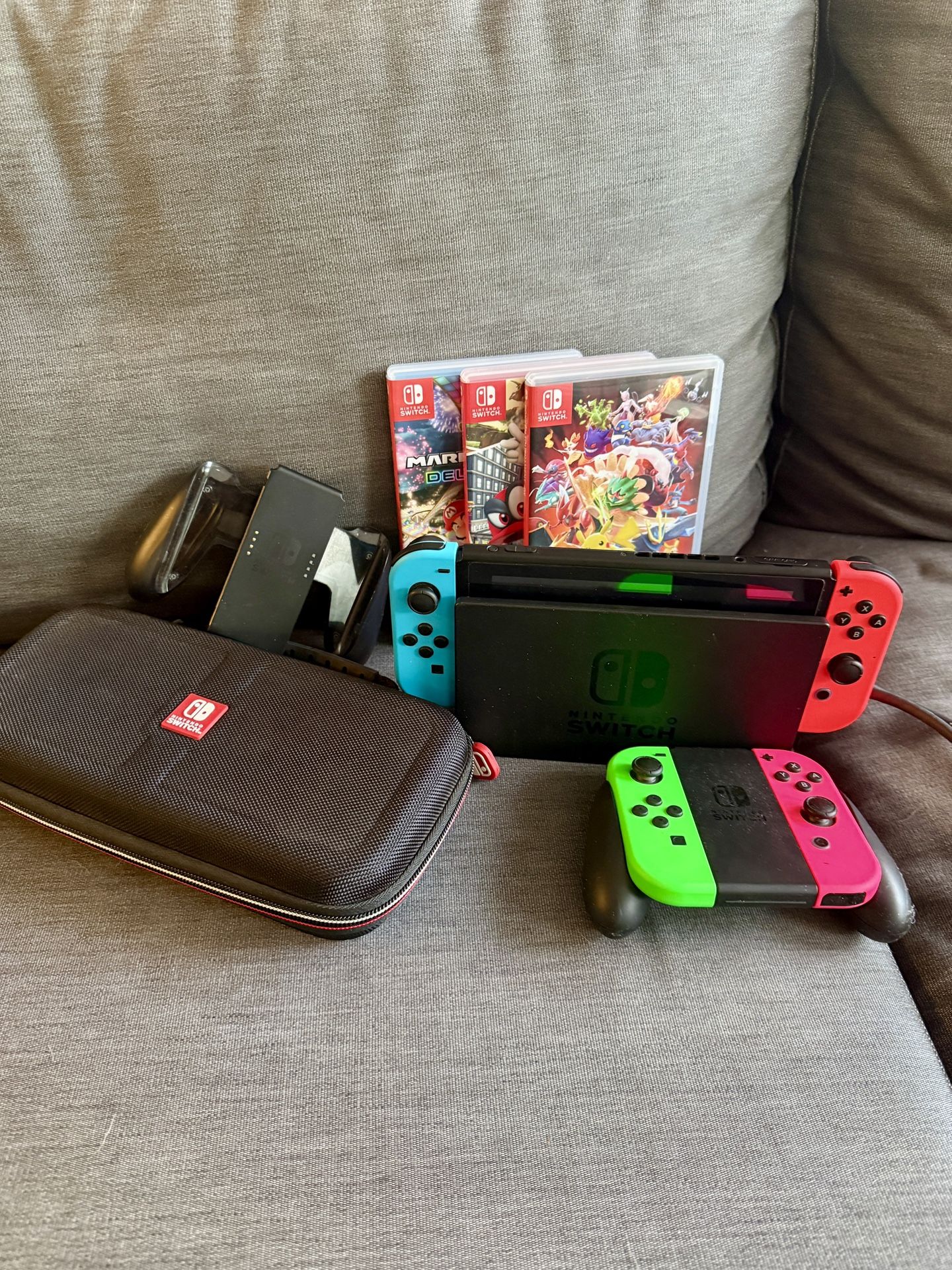 Nintendo Switch with charger stand, case, controllers, & 3 games
