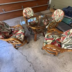 Mid century rattan  kitchen /dining room table and chairs, chairs are swivel with casters 42 in glass top good shape